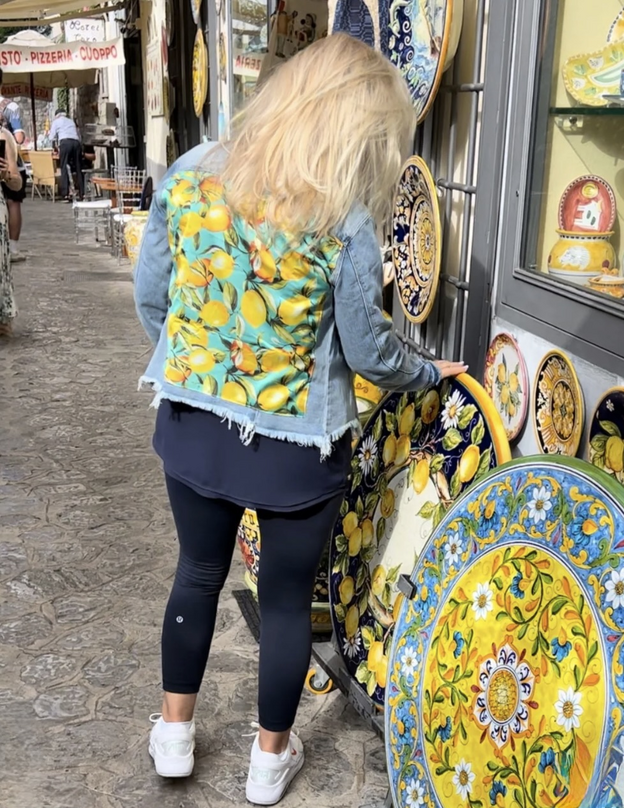 Back of woman wearing a lemon print denim jacket
