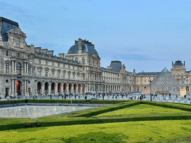 Exterior of the Louvre in Paris at dusk
