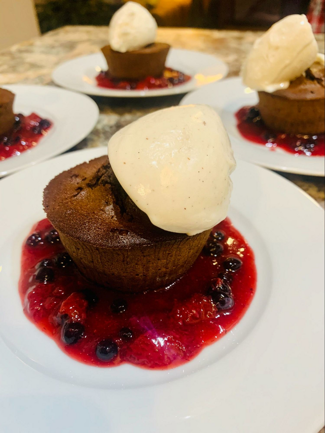 Dessert with vanilla ice cream, muffin and berry coulis.