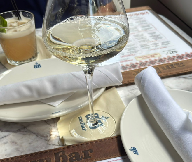 A glass of Grapefruit Spritz and a glass of wine.