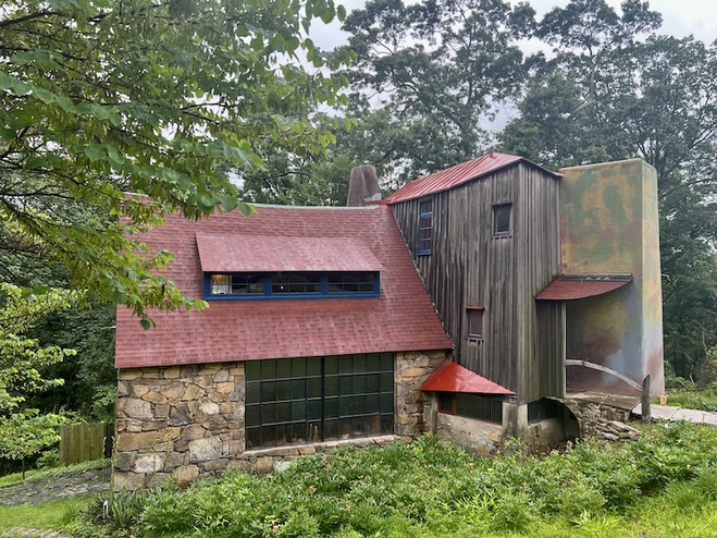 The Wharton Esherick House in Brandywine, a unique structure built from a mix of stone, wood, masonry, and shingles, showcasing an eclectic, handcrafted design.