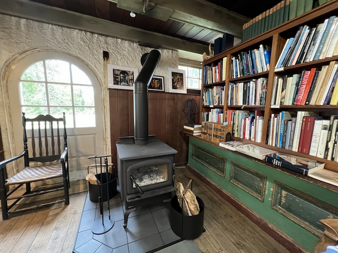 wood stove and books in shelves in the interior of bookshop