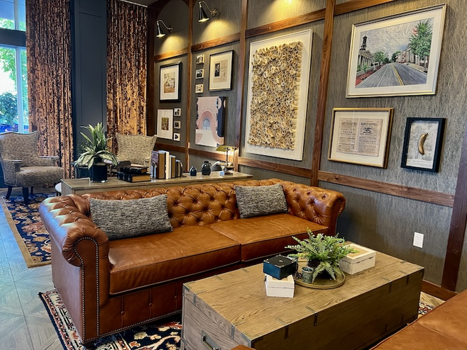 Hotel lobby with comfortable seating and framed prints decorating the walls.