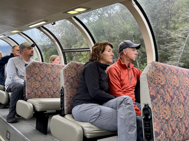 people gazing out the windows of the train.