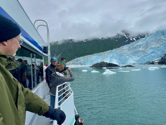 people gathered at the rail to view Glacier