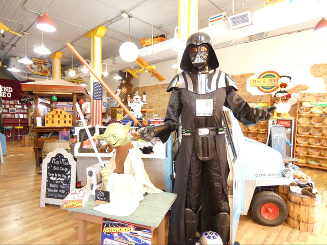 Darth Vader, and Yoda in foreground at candy store.