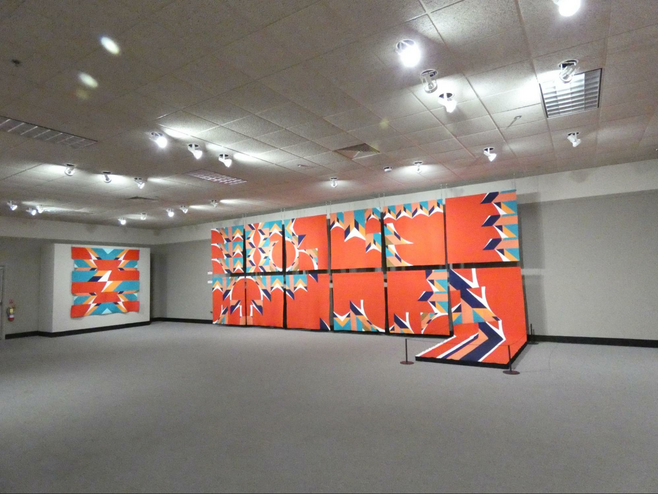 display of multiple red background quilts made with one basic idea.