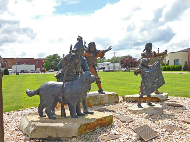 sculpture on the museum lawn portraying Meriwether Lewis, William Clark, a Native American man and child, and Clark's dog, Seaman.