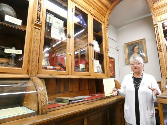 woman at museum in front of exhibit about Pearl Harbor
