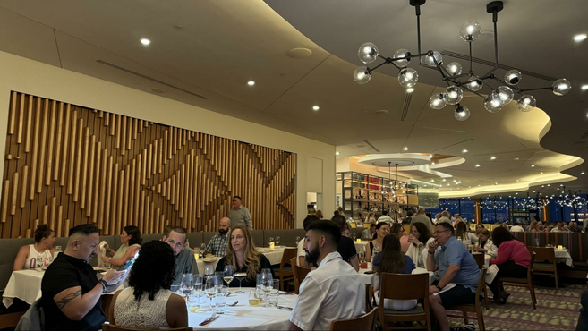 Geometric lighting fixtures, five tables with people at California Grill.
