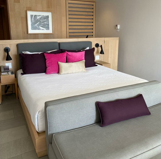 King bed with colorful decorative pillows