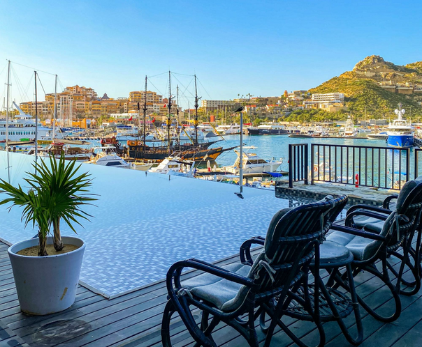 chairs in front of infinity pool near Cabo San Lucas marina