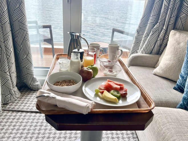 Breakfast on a tray in front of Veranda doors in stateroom