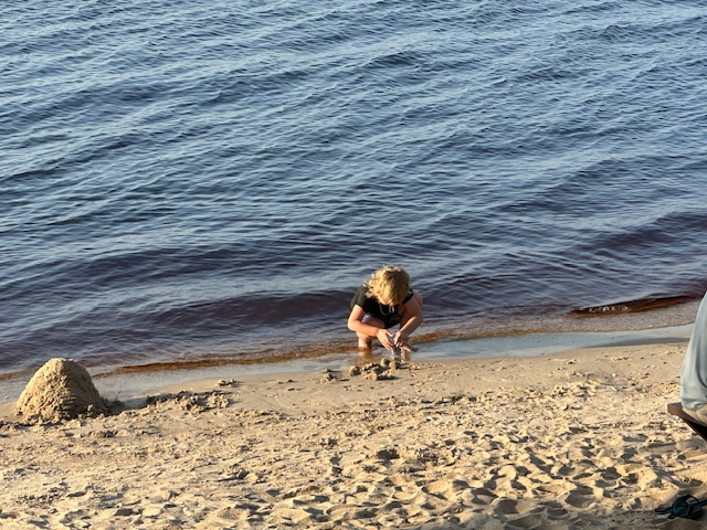 Little boy playing in the sand in Lake Minneola, Clermont, Florida. 