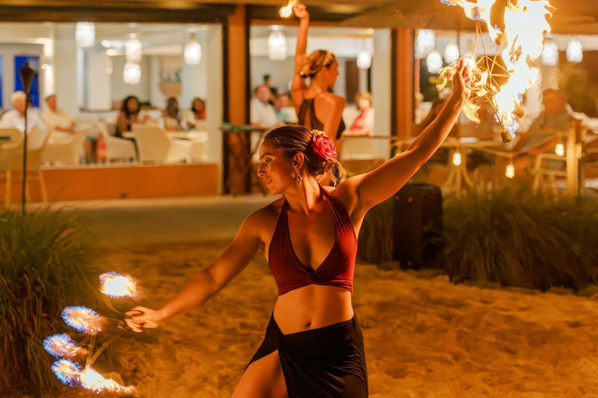 Caribbean fire dancing performing at a beach restaurant.