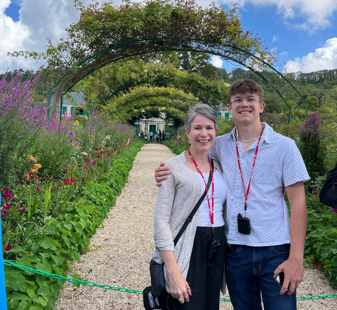 Woman and son posing in front of Monet's Gardens in Paris
