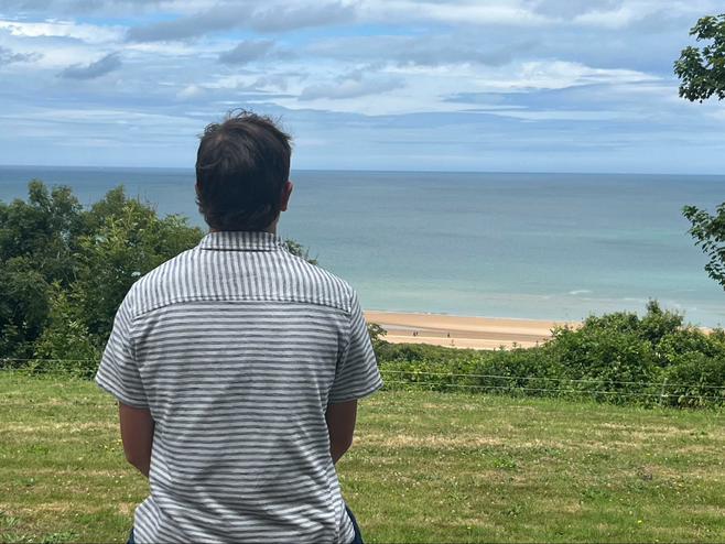 A young man looking at the beaches of Normandy