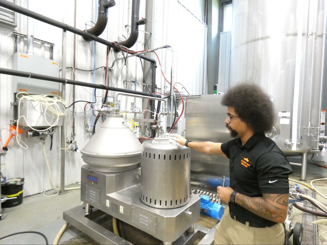 Man with brewing equiptent.