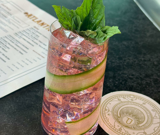 pink gin cocktail with cucumber garnish