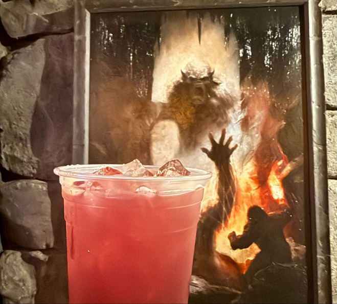 Red cocktail in front of zombie photo