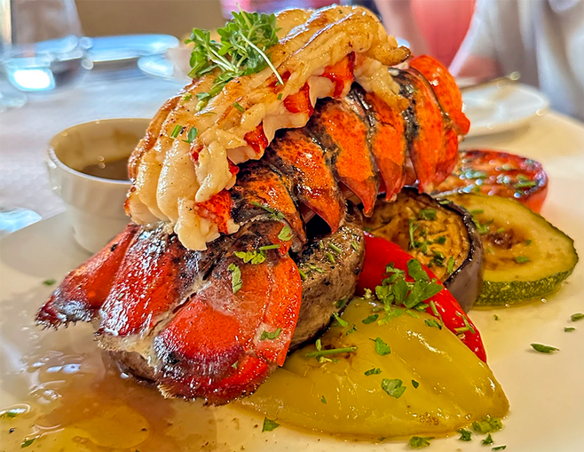 surf and turf on a bed of colorful vegetables