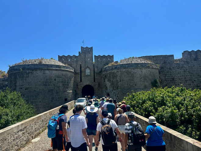 Group of tourists entering the medieval city of Rhodes, Greece