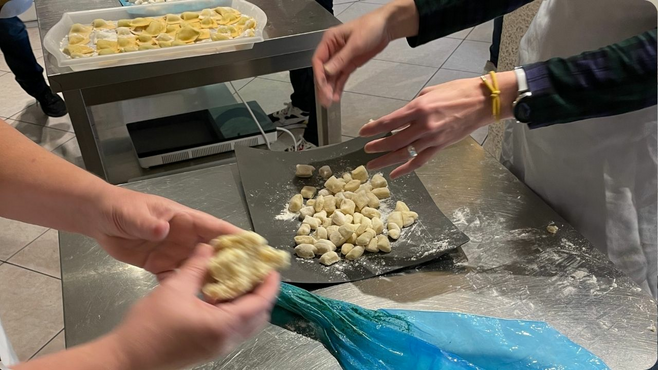 Hands making pasta from scratch in Italy