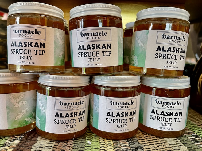 Glass jars stacked with white tops of Alaskan Spruce Jelly 