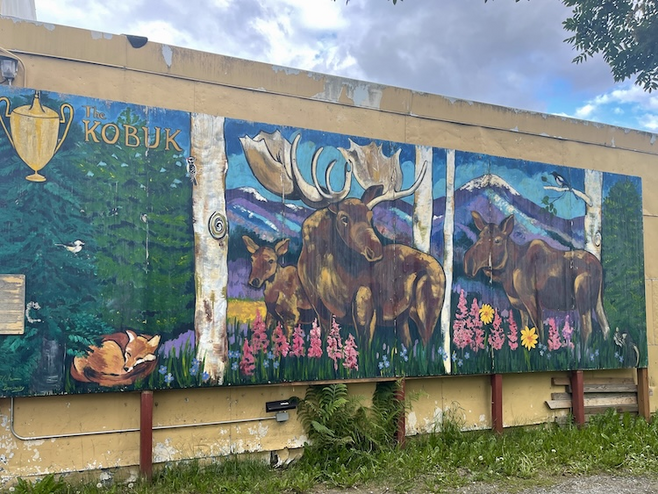 Colorful mural with moose, flowers and mountain views