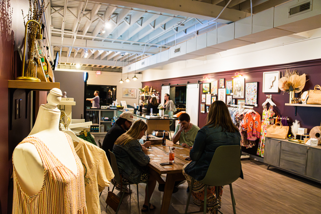 people at table playing cards in a bar