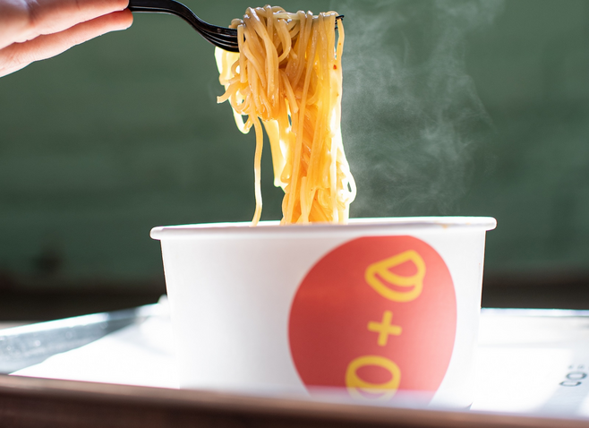 A forkful of noodles from a bowl of ramen at Optimist Hall