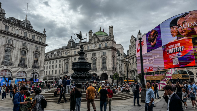 Billboards surround Piccadilly Circus. At the center is the Eros Statue.