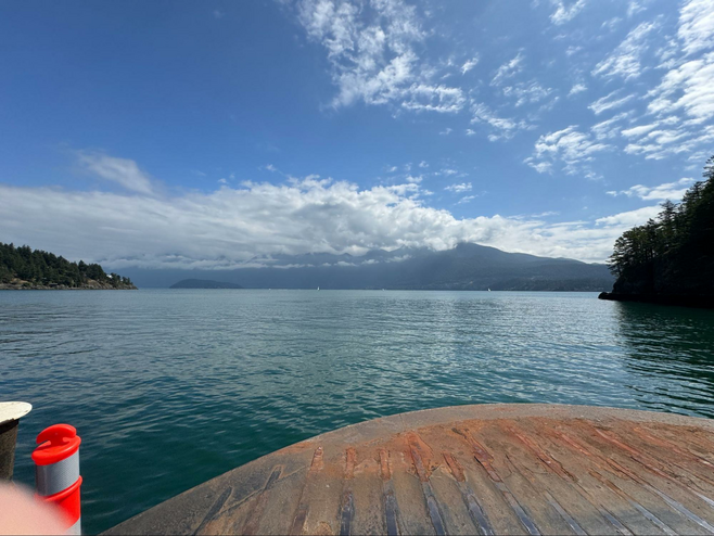View of water and mountains from a erry deck.