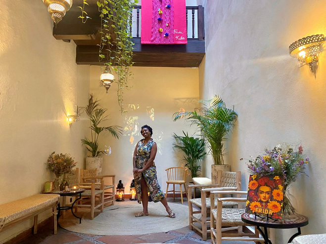 Woman standing in the middle of a room surrounded by chairs
