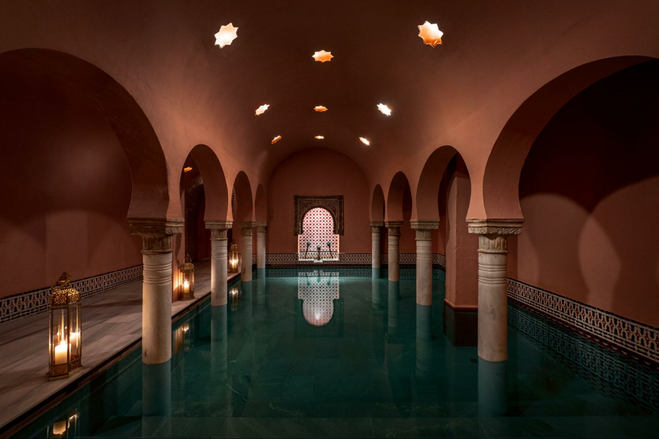 Pool with arched pillars and candles