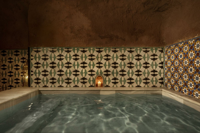 swimming pool with decorative walls and candle