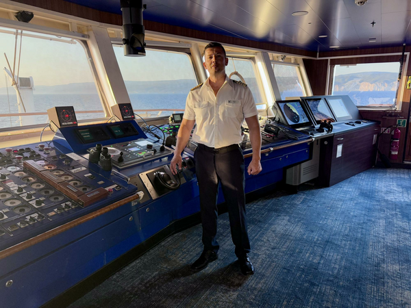 Captain of ship on bridge.