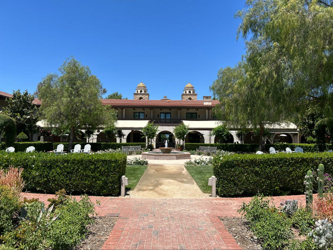 Ponte vineyard inn exterior, complete with lush gardens, greenery and water fountains In Temecula