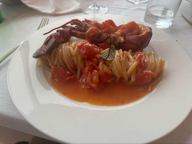 Dinner plate with lobster and pasta at Renaissance Naples Hotel Mediterraneo