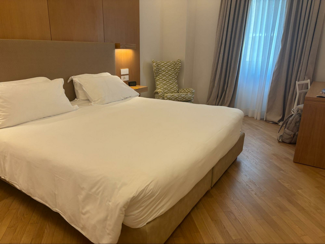 King size bed in hotel room at Renaissance Naples Hotel Mediterraneo