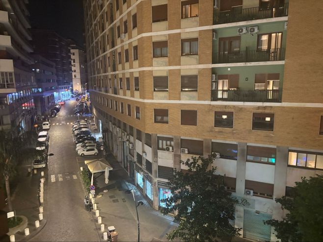 City street at night in Naples, Italy from hotel room view