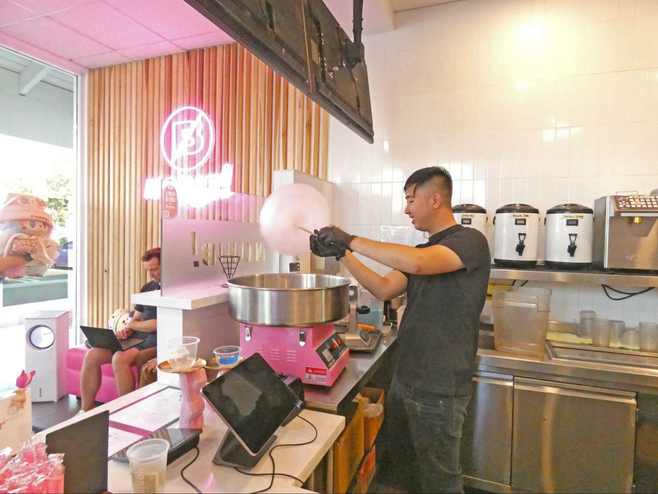 Server spinning cotton candy to make a Dream Cloud.