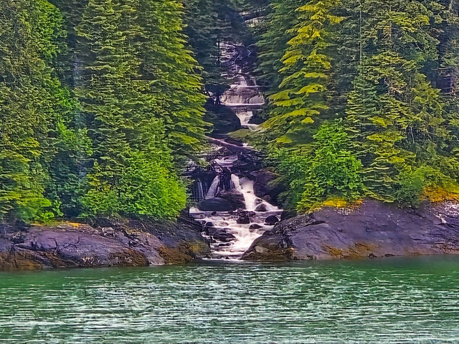 View of mountain waterfall from cruise ship balcony on Discovery Princess in Alaska