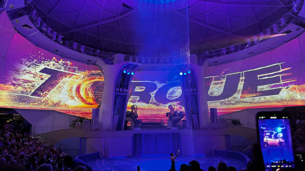 Screen with the word Torque in bold black letters with a white stage and a pool. 