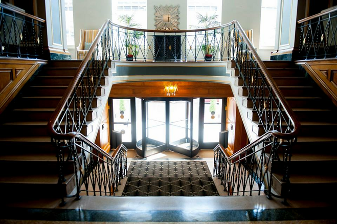 Double stairway inside historic hotel lobby of the Tiger Hotel in Columbia, Missouri, is reminiscent of classic architecture.