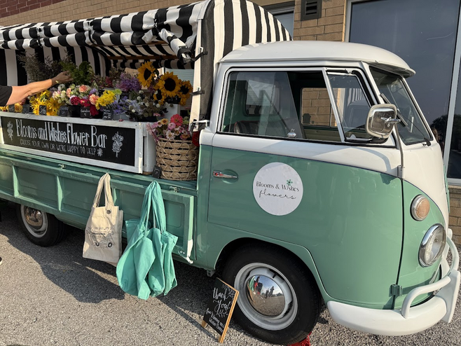 An updated Volkswagon van renovated into a flower cart in Columbia, Missouri, is a popular place to buy custom flower arrangements during the Friday night art crawl.