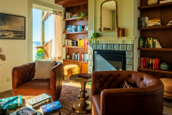 Chairs in front of a fireplace in the lobby at Hotel Sylvia, Newport, Oregon