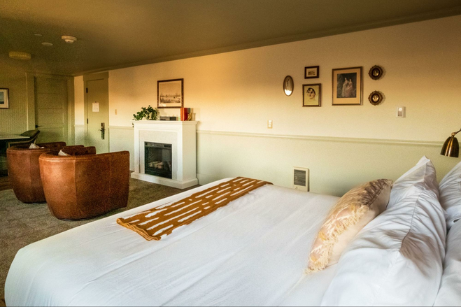 Guest bedroom with fireplace at Hotel Sylvia, Newport, Oregon