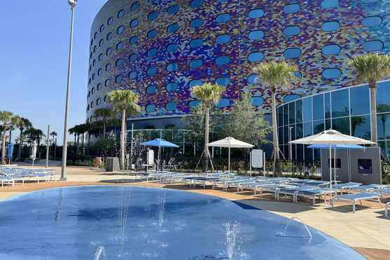 Splash pad surrounded by lounge chairs at Universal Stella Nova Resort pool.