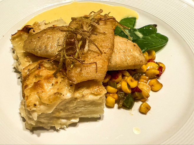 sauteed fish served with potato, succotash and sauce